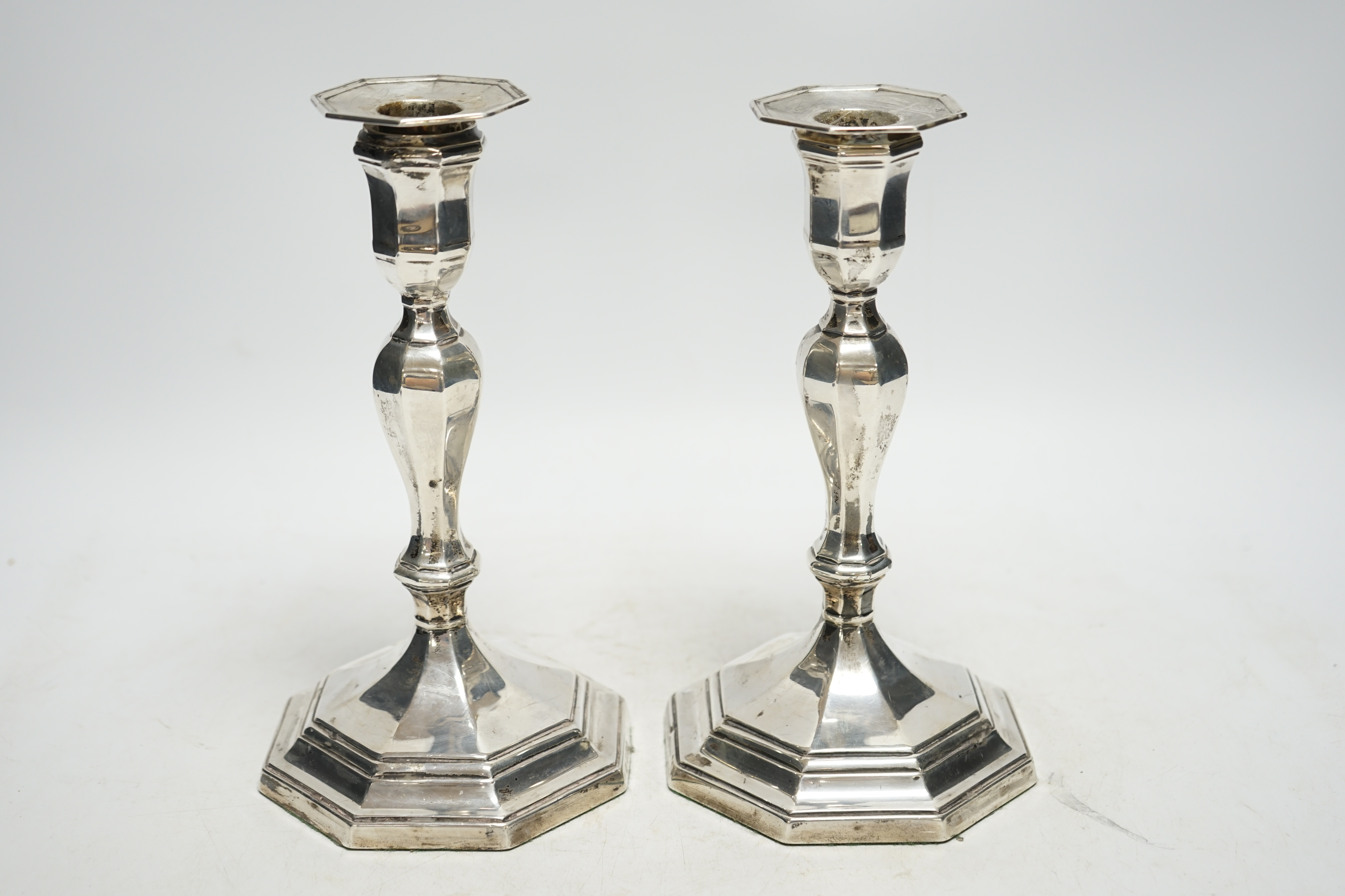 A pair of Edwardian silver octagonal candlesticks, Hawksworth, Eyre & Co Ltd, Sheffield, 1905, 21.7cm, weighted. Condition - average to fair